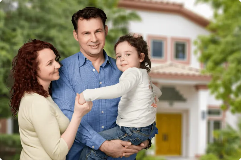 Familie vor ihrem Eigenheim